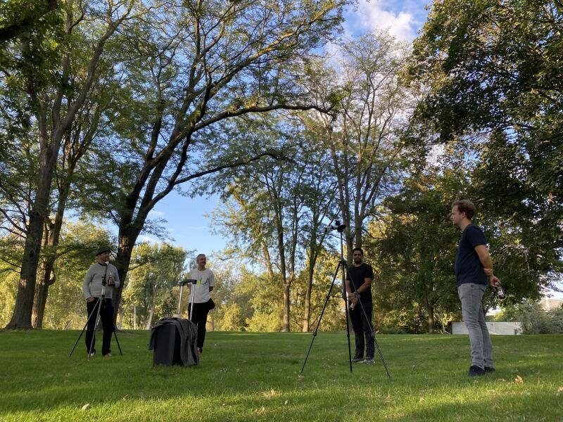 People gathered around a table in a park